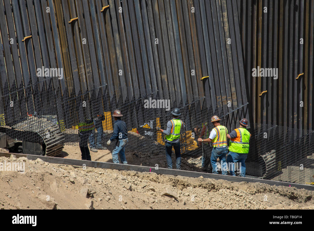 Workers set into place a section of border fence near El Paso, Texas, part of the privately-funded scheme by We Build The Wall, Inc. 30 May 2019 Stock Photo
