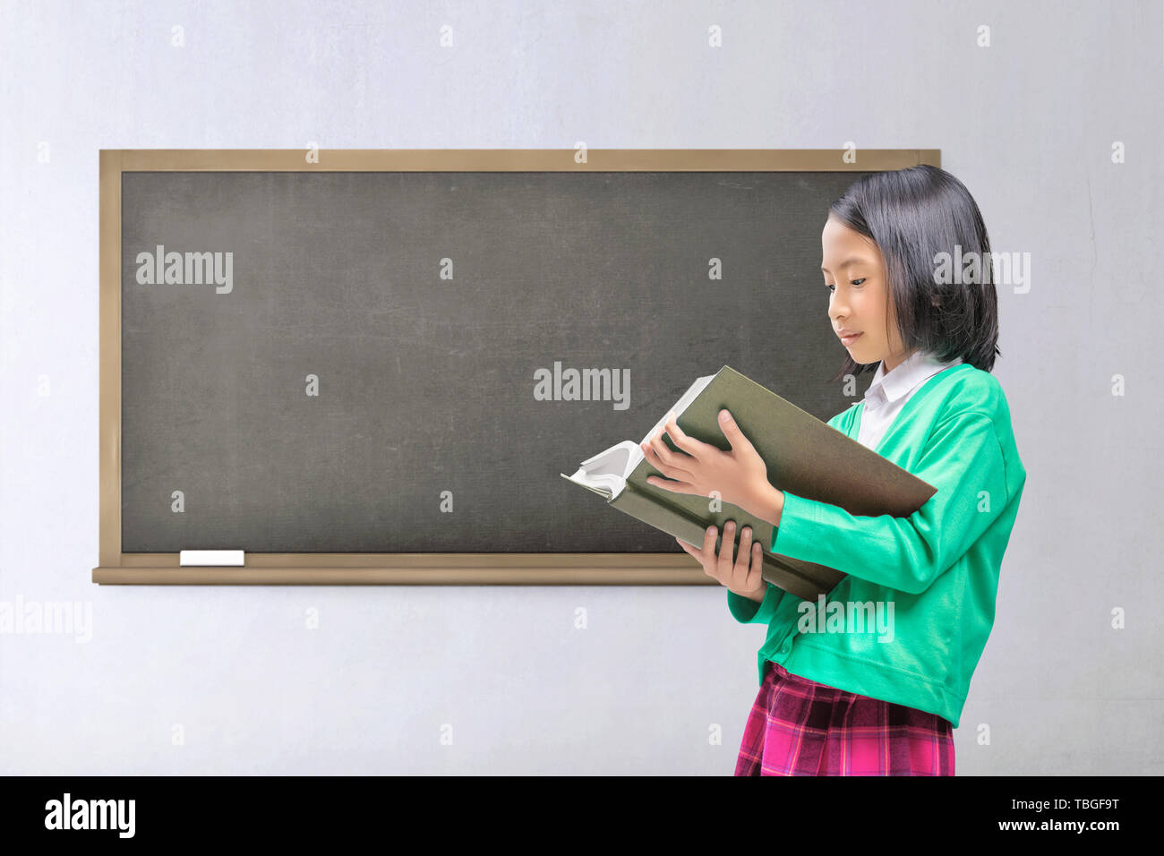 Young asian kid reading book with class background Stock Photo
