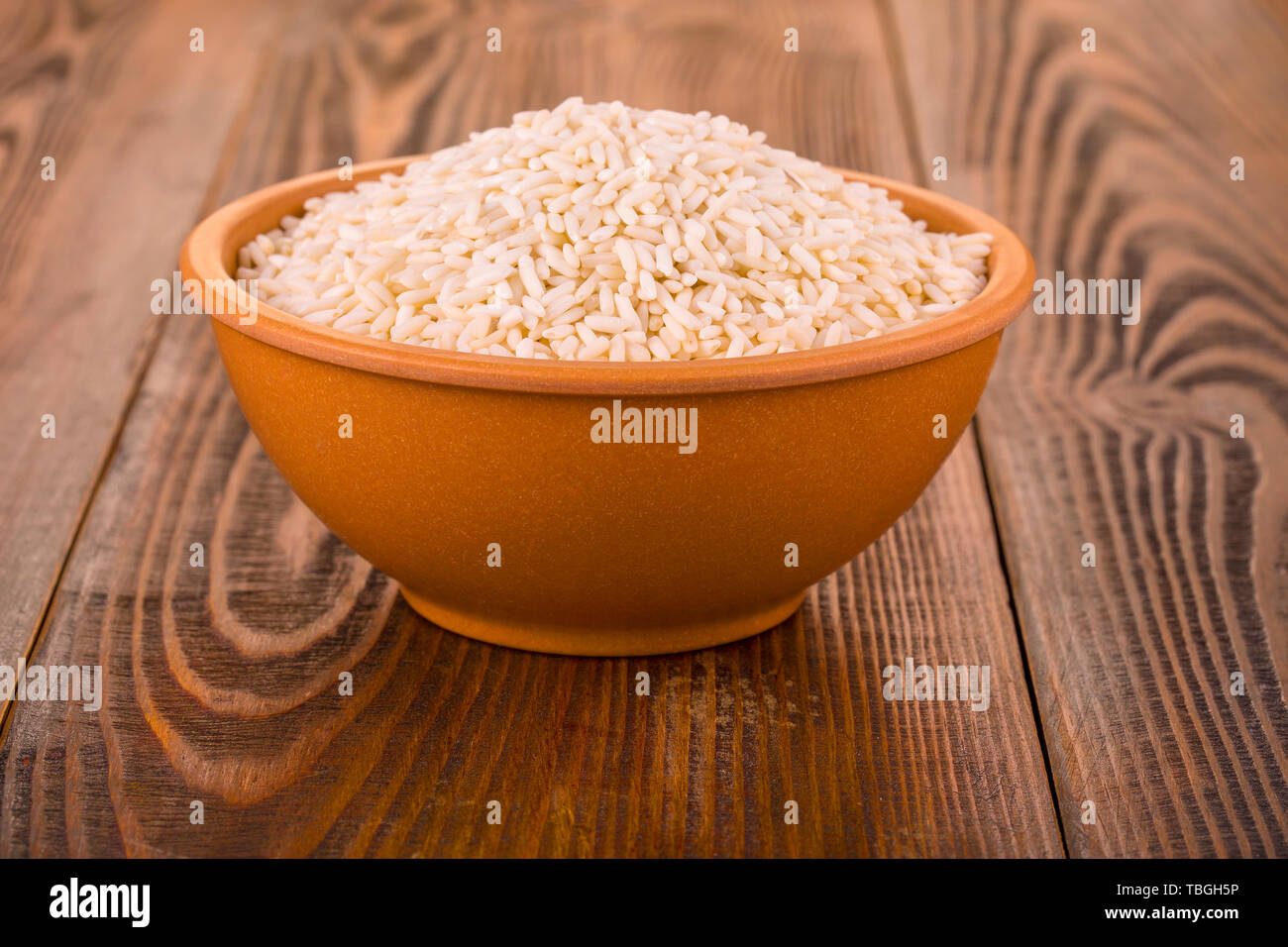 Raw White Rice In A Cup On A Wooden Table Stock Photo Alamy Raw White Rice In A Cup On A Wooden Table Stock Photo Alamy
