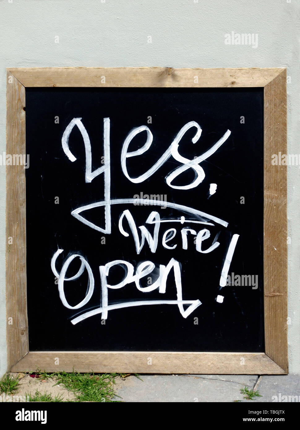 Yes, we are open sign. On outdoor cafe Stock Photo