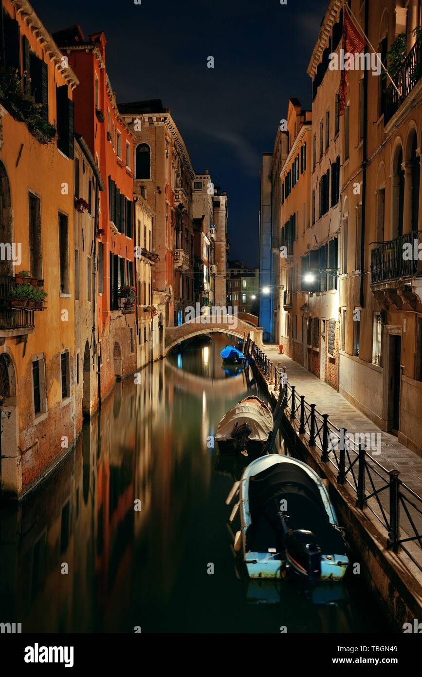Venice canal view at night with bridge and historical buildings. Italy. Stock Photo