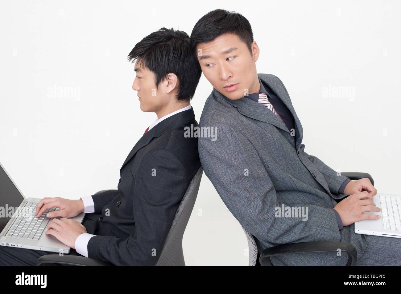 Young man sitting suit hi-res stock photography and images - Alamy
