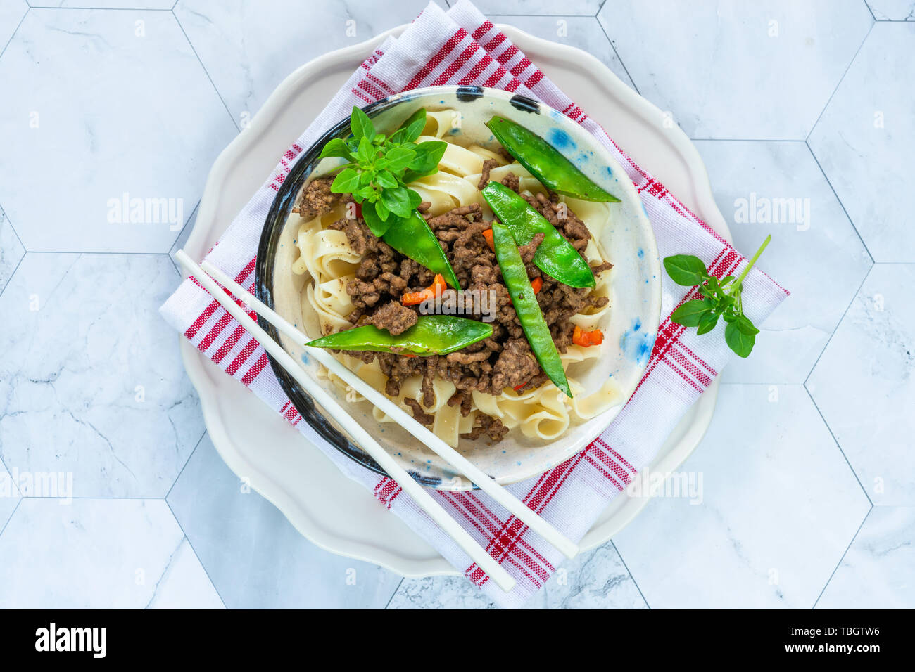 Chinese fivespice beef and sugar snap noodles top view Stock Photo