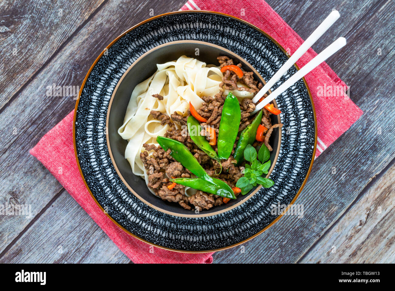 Chinese fivespice beef and sugar snap noodles top view Stock Photo