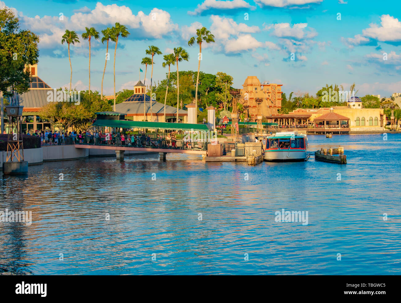 Orlando, Florida . March 27, 2019. People boarding taxi boat on dock and panoramic view of Italy Pavilion at Epcot in Walt Disney World . Stock Photo
