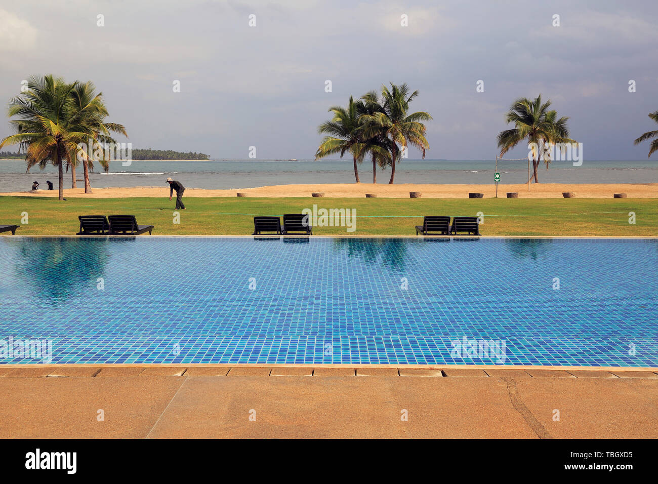 Gardener and pool Amaya Beach Resort and Spa hotel, Pasikudah Bay, Eastern Province, Sri Lanka, Asia Stock Photo