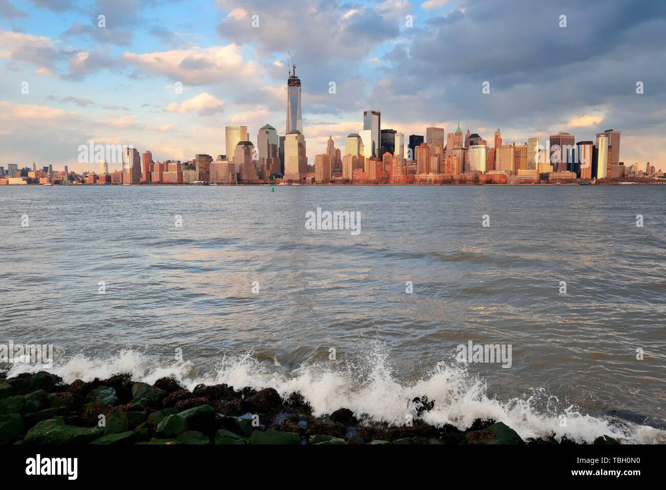 Downtown Manhattan skyline at sunset over Hudson River in New York City ...