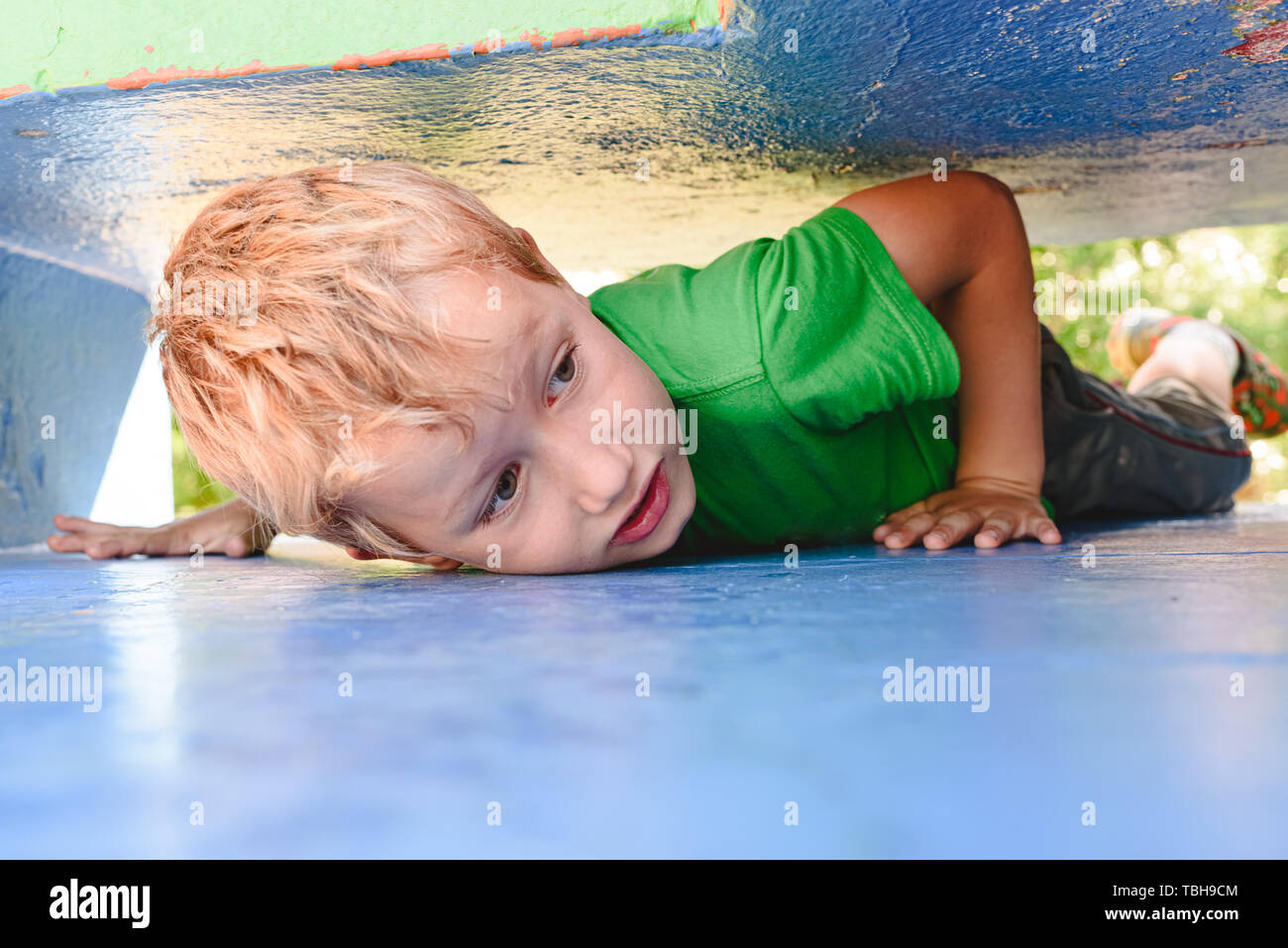 Child playing hide and seek in an urban concrete maze looking for fun