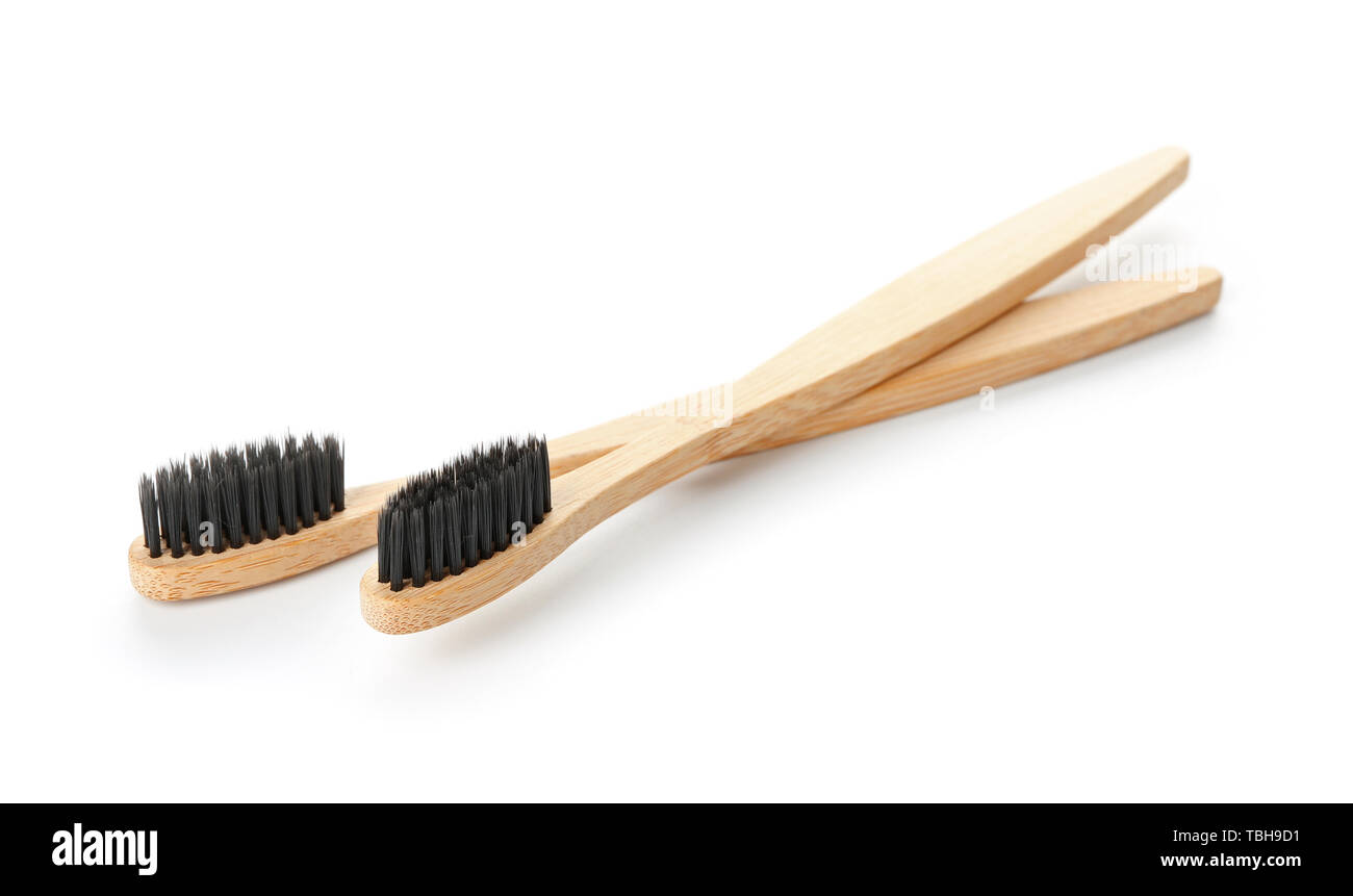 Wooden toothbrushes on white background Stock Photo - Alamy