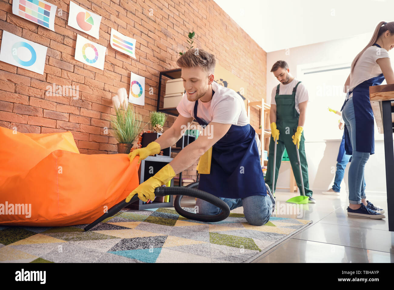 Male janitor cleaning office Stock Photo