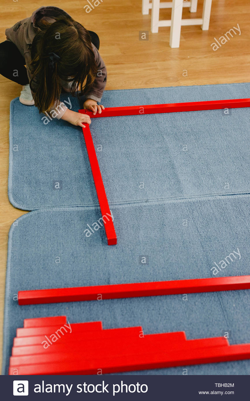 Girl Is A Class Of A School Placing The Red Bars Montessori On A