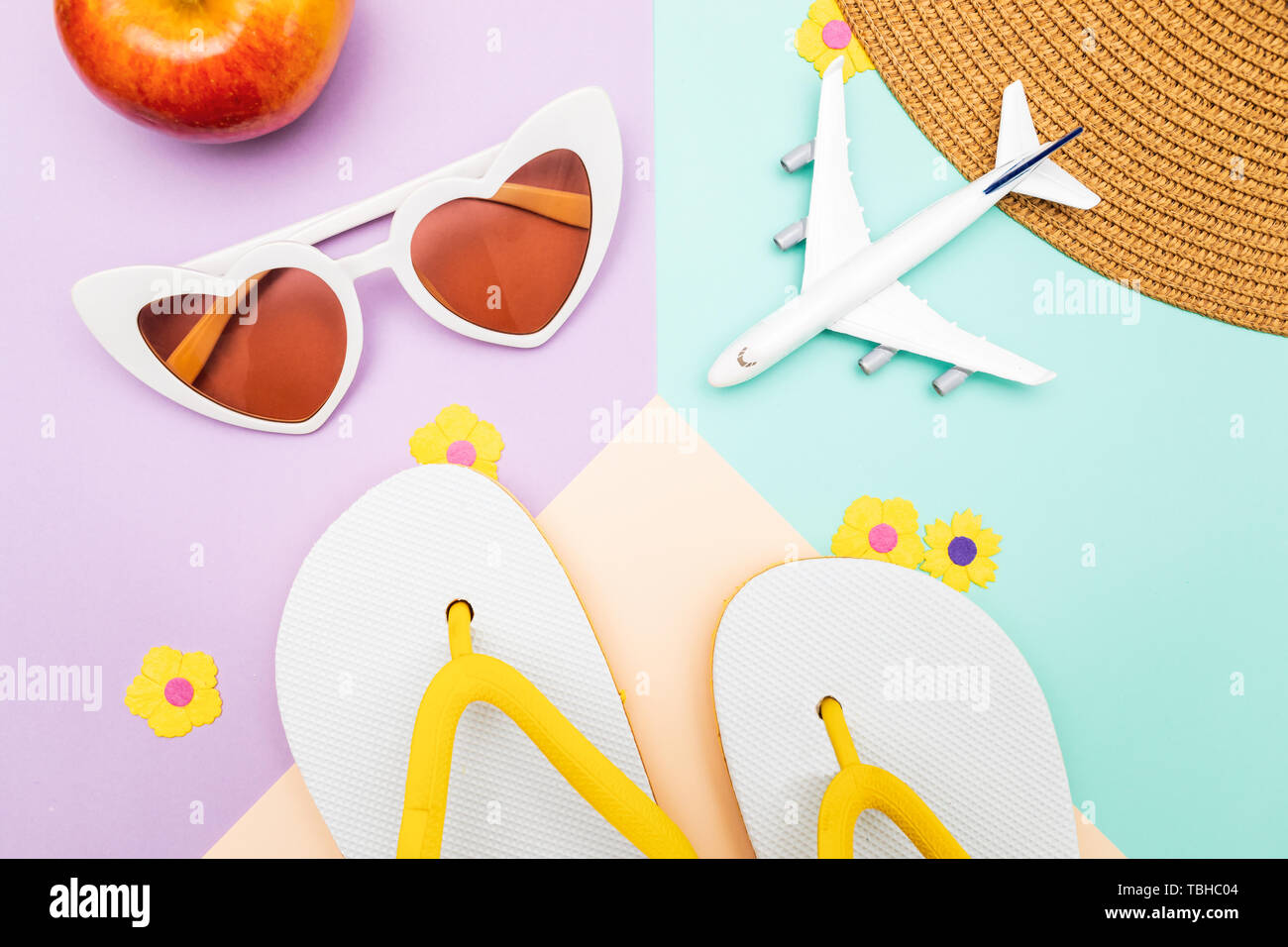 top view of summer flat lay travel background. flip flops, sunglasses and plane Stock Photo