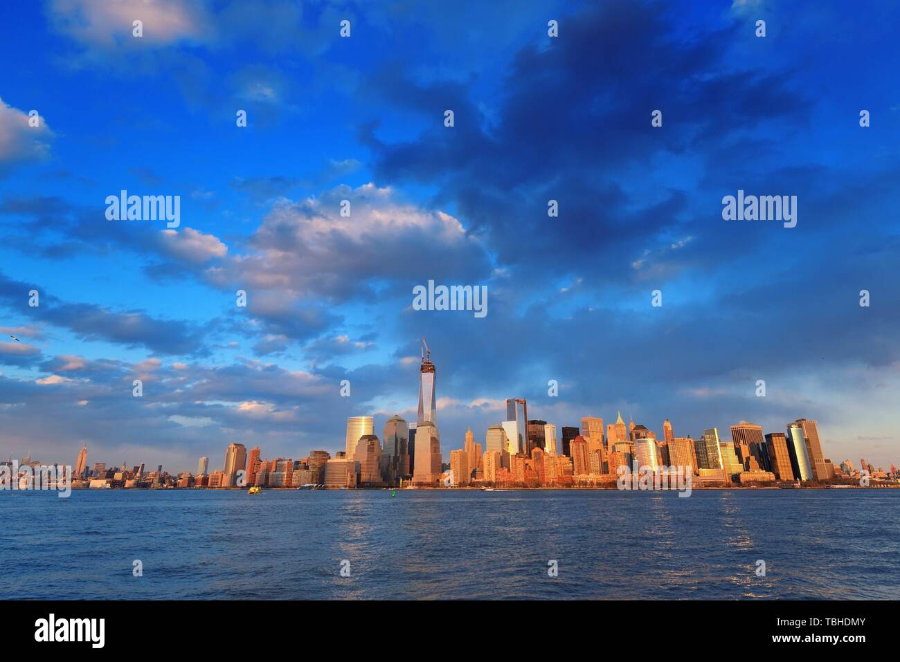 Downtown Manhattan skyline at sunset over Hudson River in New York City ...