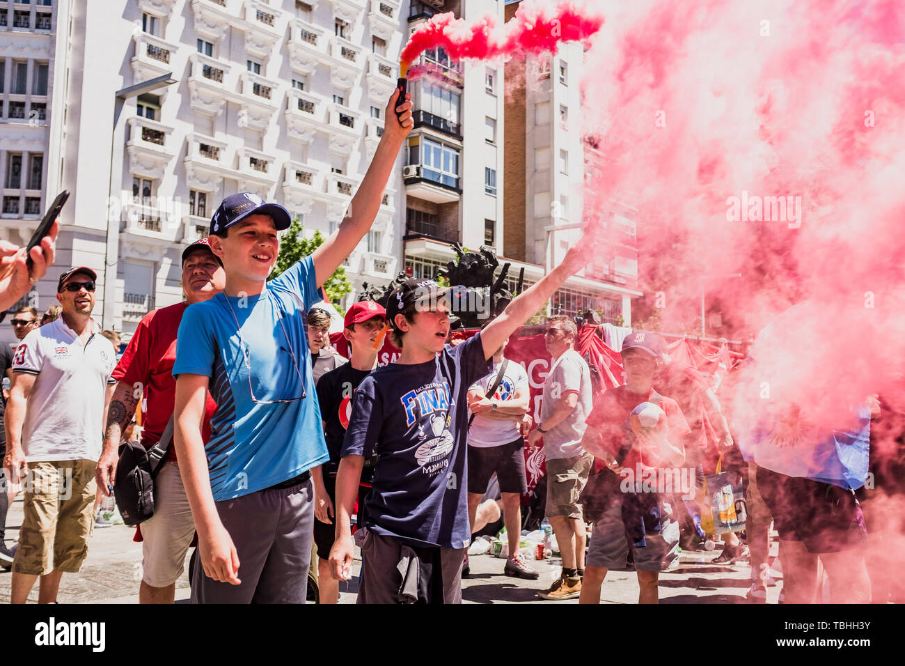 Young supporters burn flares at the Liverpool fan zone. Madrid hosts the UEFA Champions League Final between Liverpool and Tottenham Hotspur at the Wanda Metropolitano Stadium. Stock Photo