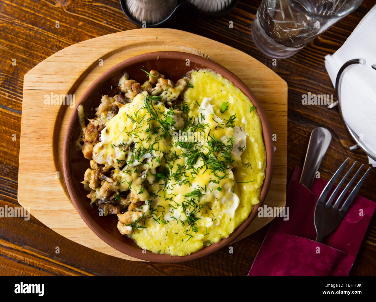 Stewed chicken with mushrooms and onion served with mashed potatoes and