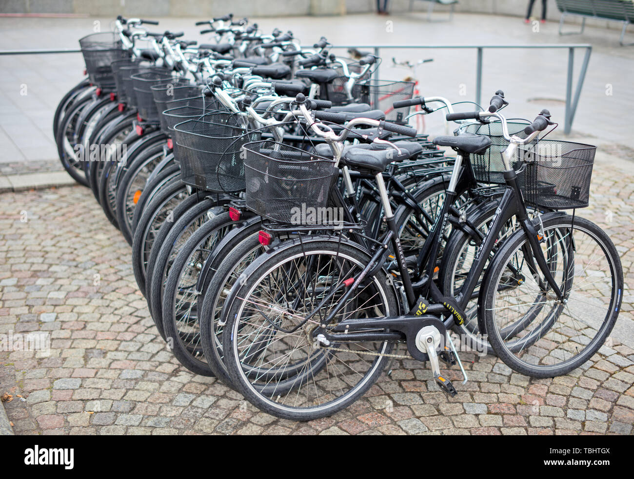 Bicycles in a row in Södra Blasieholmshamnen, Stockholm, Sweden, during a rainy day Stock Photo