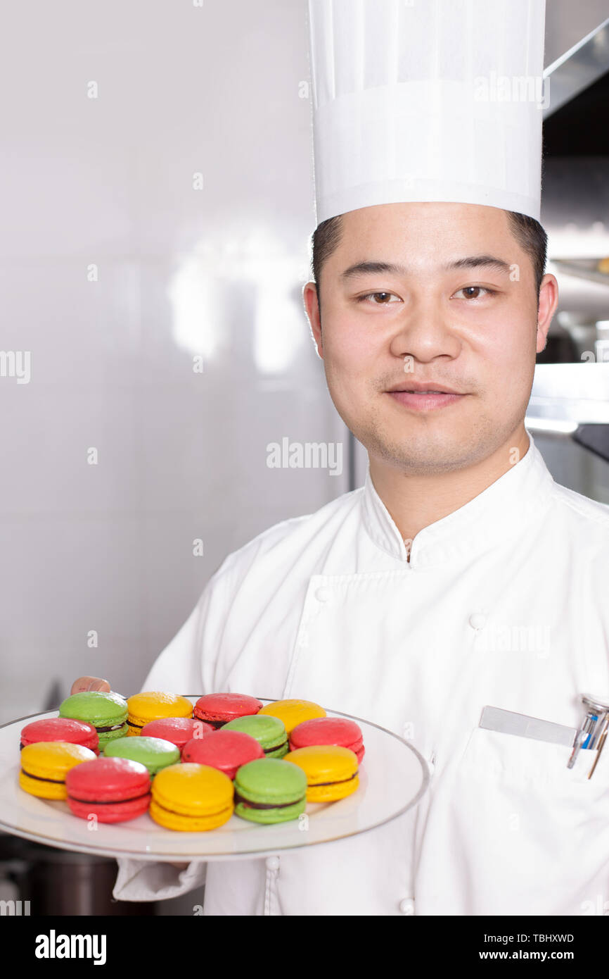 young chinese man chelf making food in modern kitchen Stock Photo Alamy