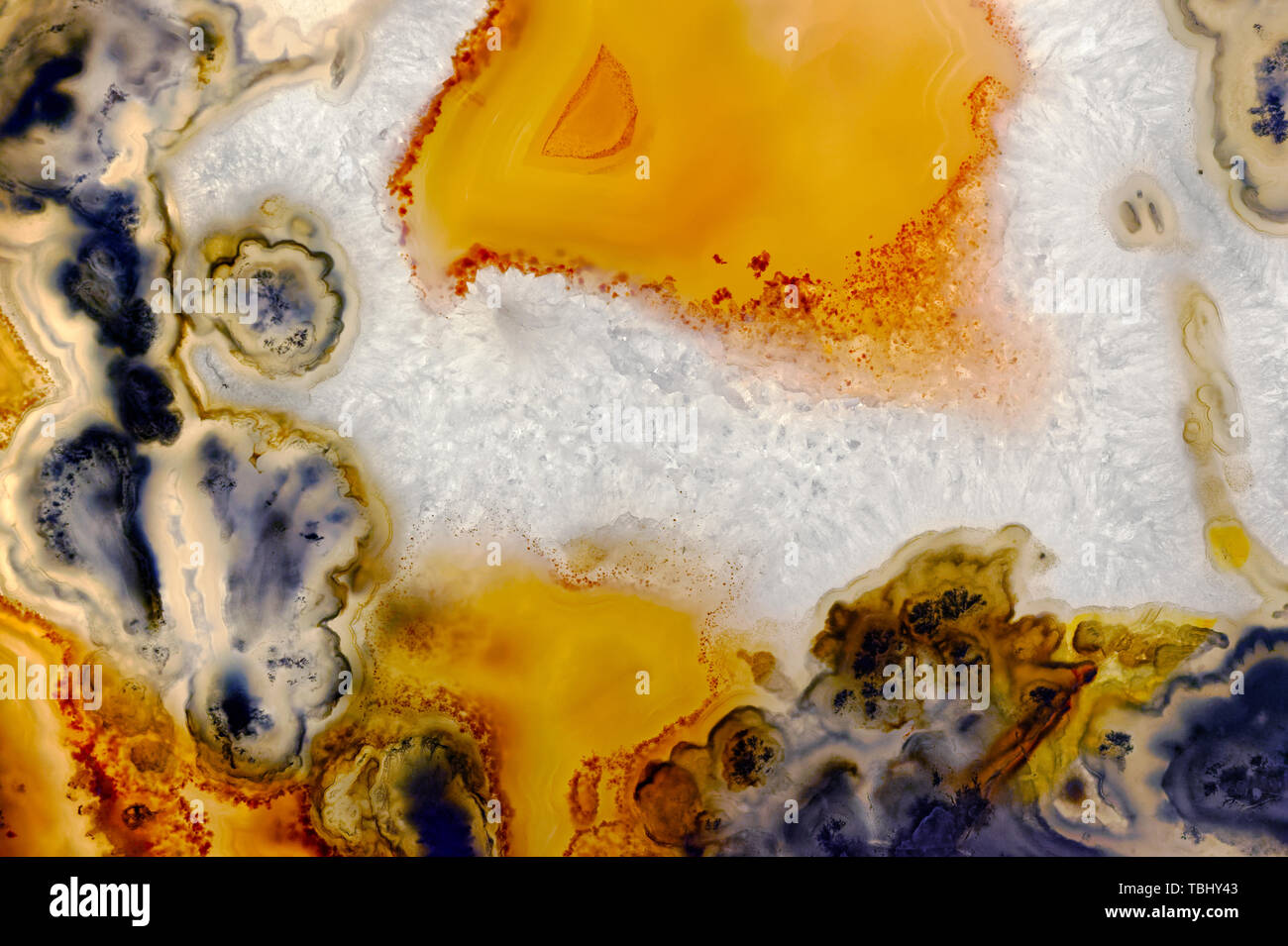 Backgrounds and textures: surface of agate or chalcedony, beautiful decorative stone, abstract pattern of cracks, spots and stains, natural background Stock Photo