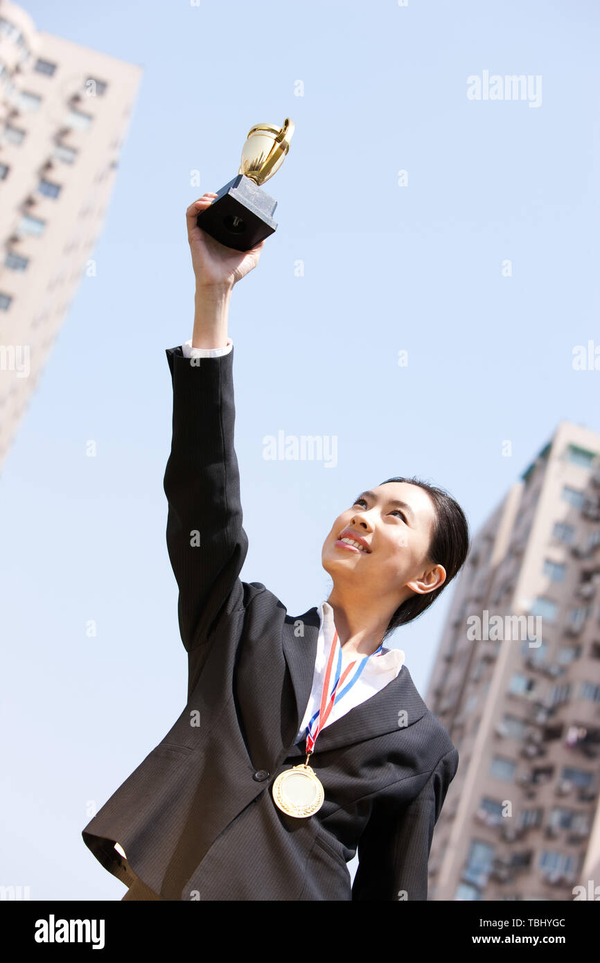 Asian woman gold medal trophy hi-res stock photography and images - Alamy
