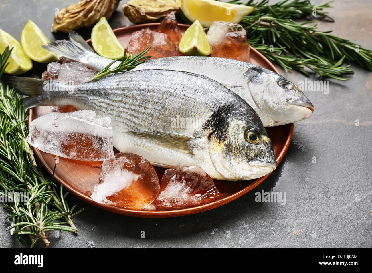 Fresh fish on grey table Stock Photo - Alamy