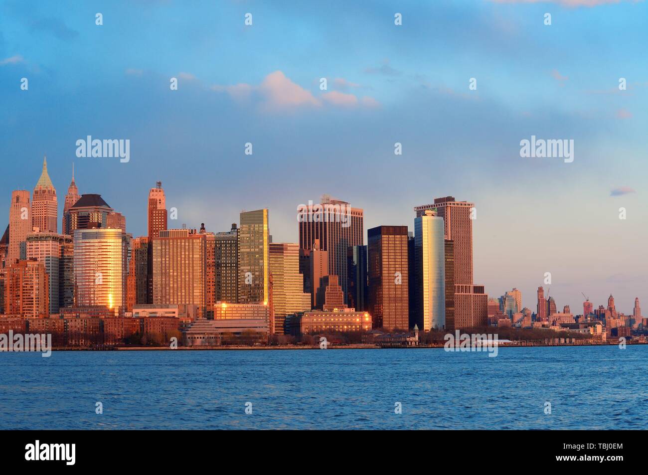 Downtown Manhattan skyline at sunset over Hudson River in New York City ...