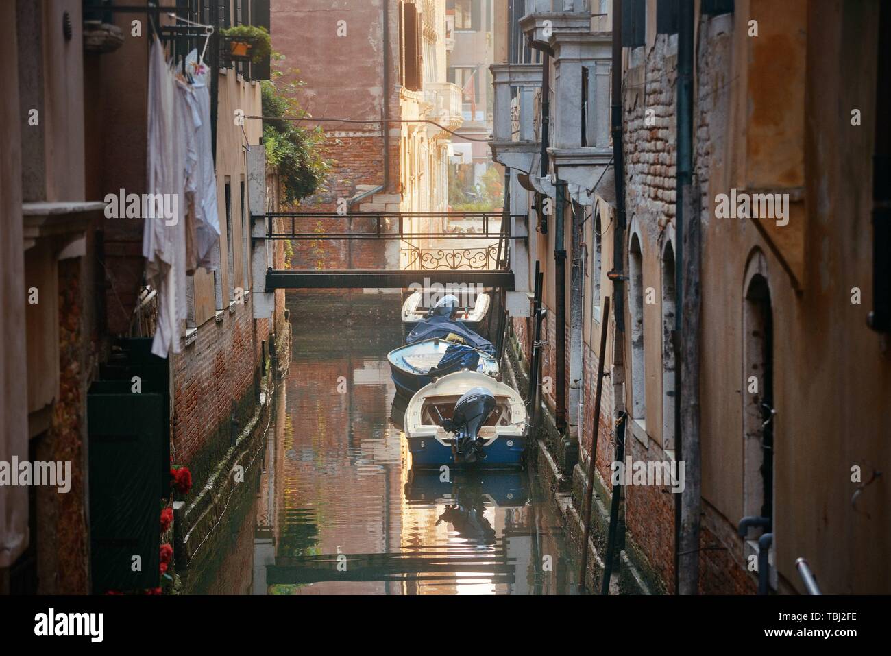 Boat park in Venice alley canal. Italy Stock Photo - Alamy
