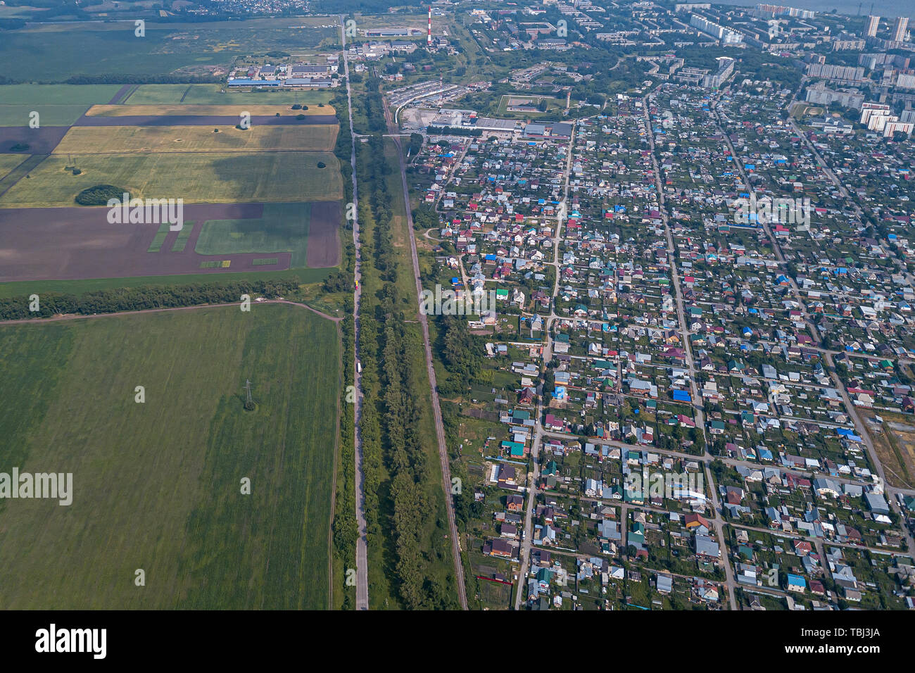 Aerial view of a small town with low-rise buildings and houses with ...