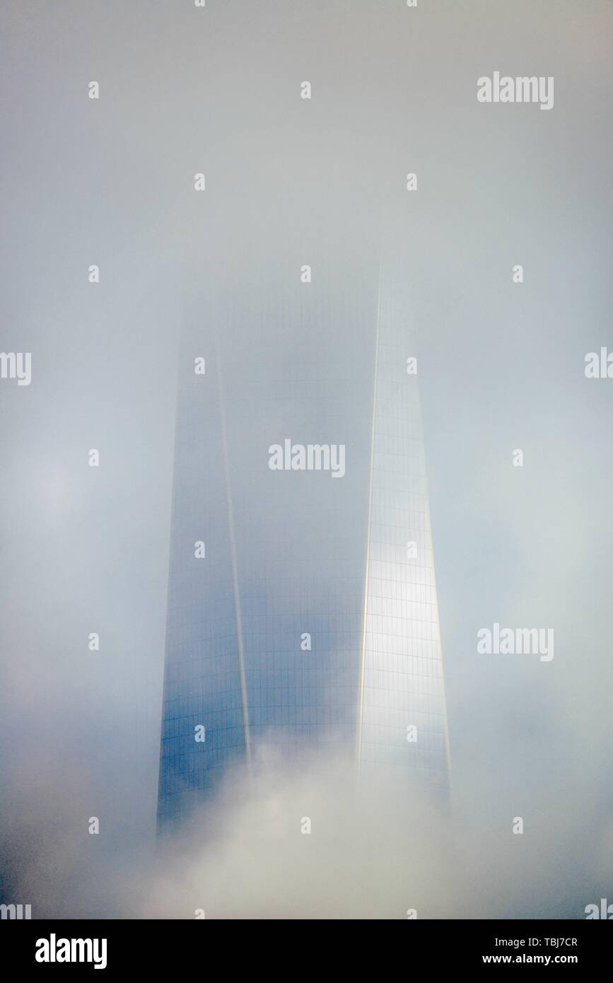 NEW YORK CITY - NOV 12: One World Trade Center in fog on November 12, 2014 in Manhattan, New York City. With population of 8.4M, it is the most populous city in the United States. Stock Photo