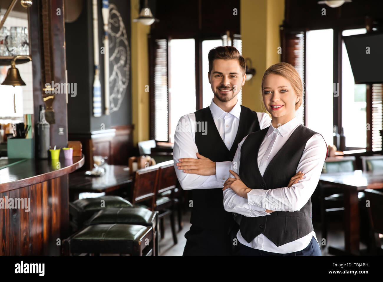 Young waiters in restaurant Stock Photo