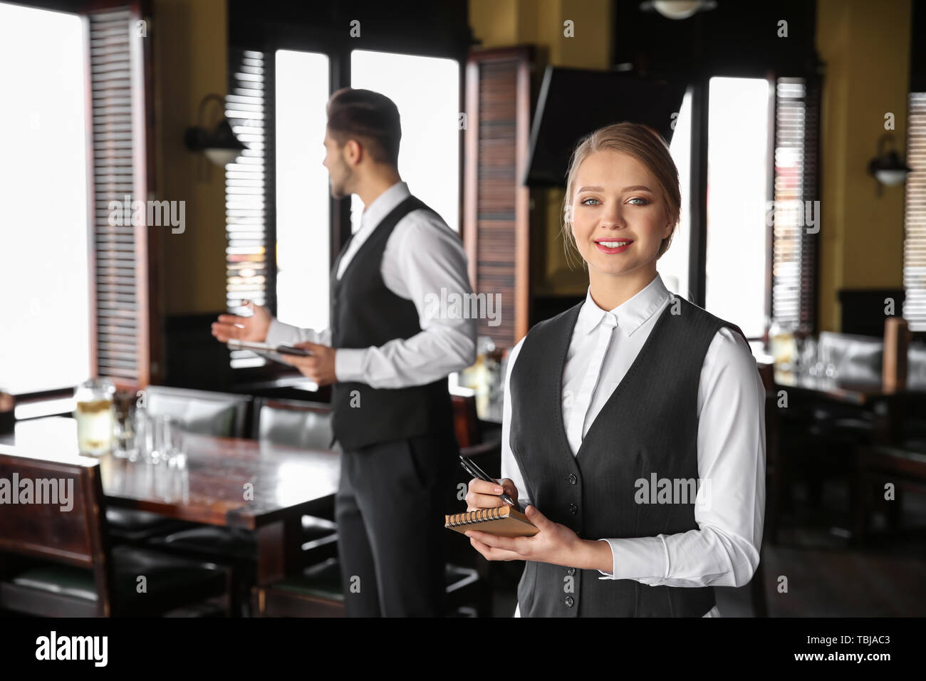 Young waiters in restaurant Stock Photo Alamy