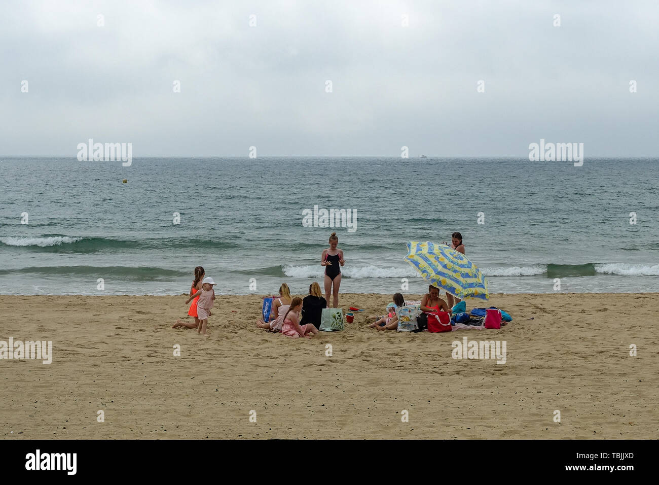 Bournemouth, Dorset, UK, 2nd June 2019. A cool start in the south of England meant that some visitors to the beach were well wrapped up in coats and hoodies. This family braved the chill in their swimming costumes.  The forecast was for 29 degrees Celsius but has only reached 20 degrees mid morning with a cool wind. Credit: Mick Flynn/Alamy Live News Stock Photo