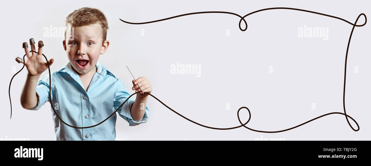 boy with a needle and thread in a blue shirt on a light background ...