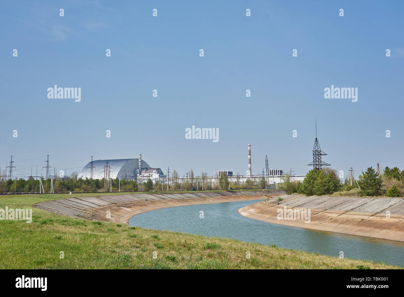 nuclear reactors of Chernobyl power plant next to Pripyat river, 4th (exploded) reactor with sarcophagus on left, 3th reactor on right, Exclusion zone Stock Photo