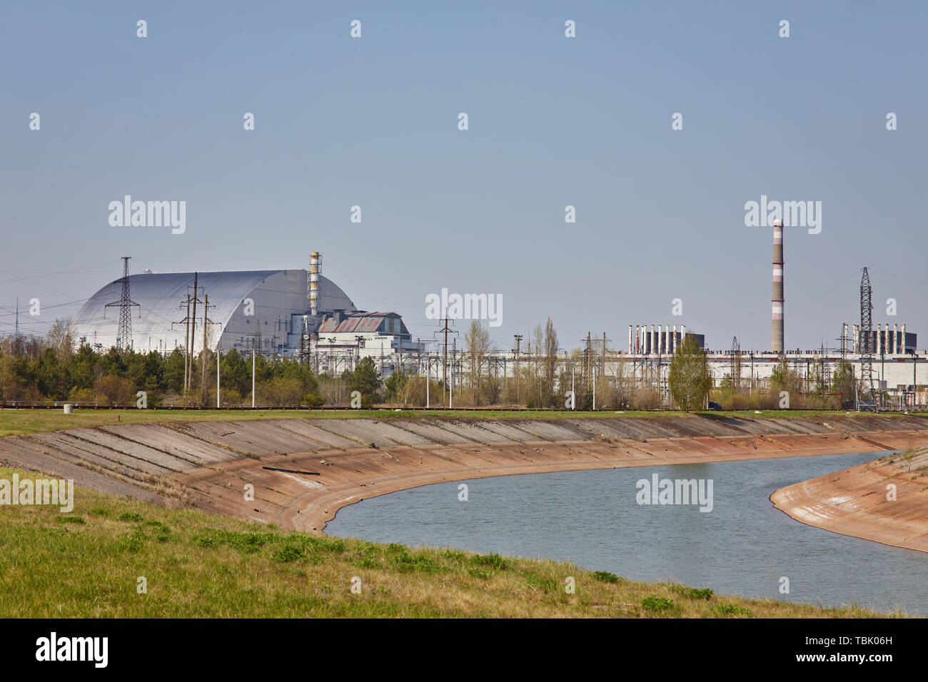 nuclear reactors of Chernobyl power plant next to Pripyat river, 4th (exploded) reactor with sarcophagus on left, 3th reactor on right, Exclusion zone Stock Photo