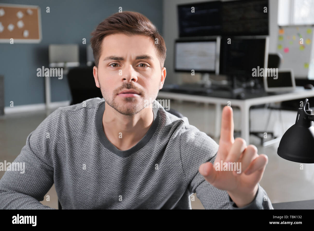 Male programmer using virtual screen in office Stock Photo