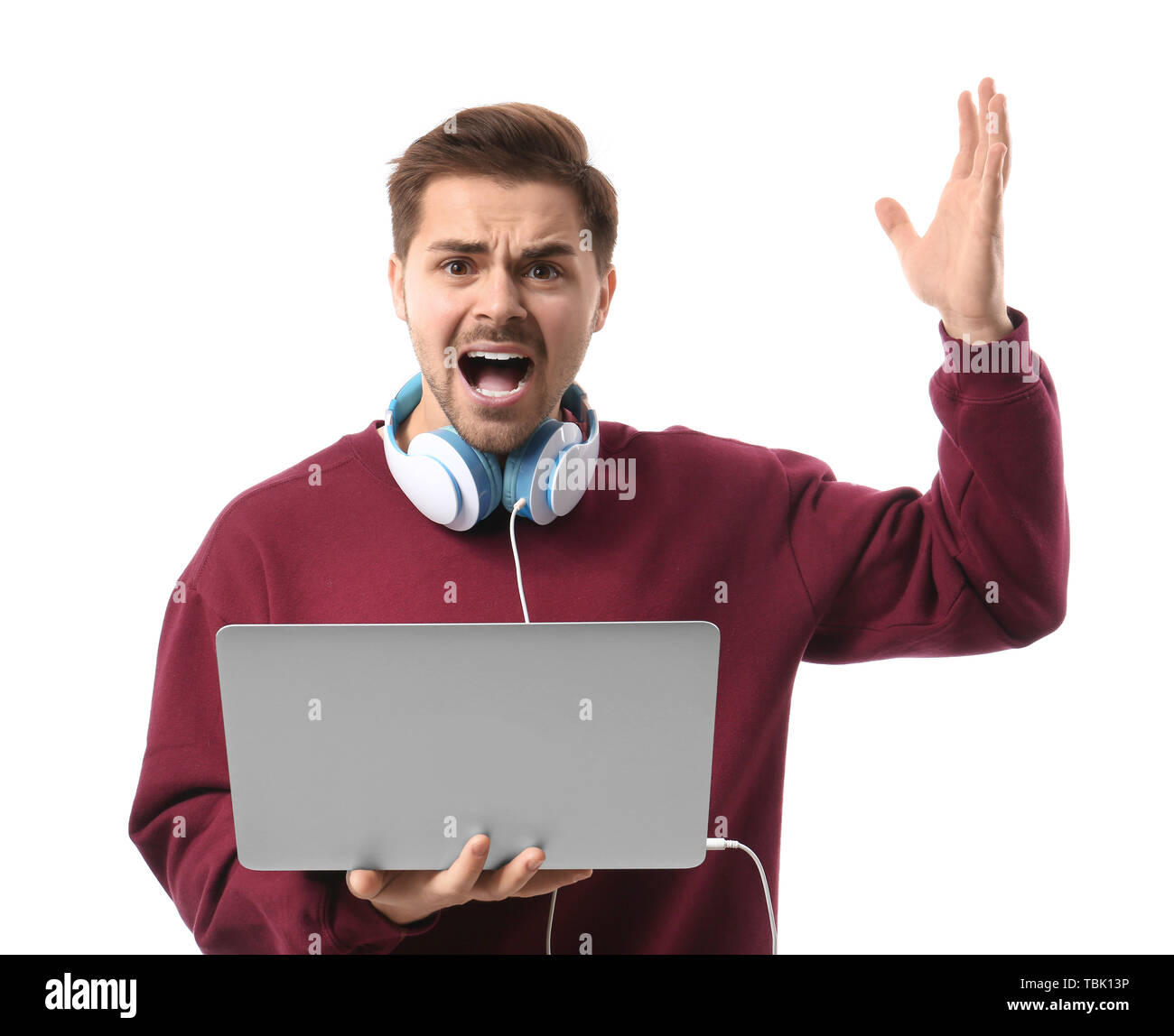 Stressed male programmer with laptop on white background Stock Photo