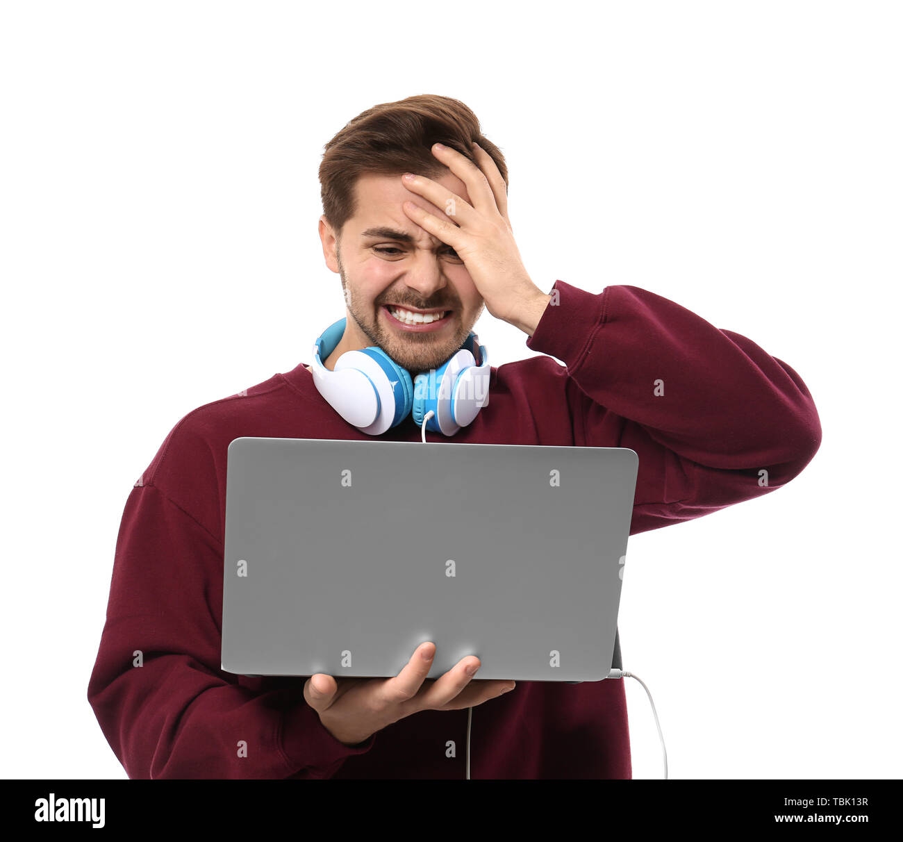 Stressed male programmer with laptop on white background Stock Photo