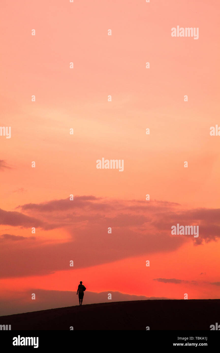 Lonely man walking sunset hi-res stock photography and images - Alamy