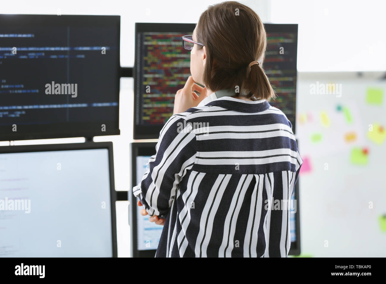 Female programmer working in office Stock Photo