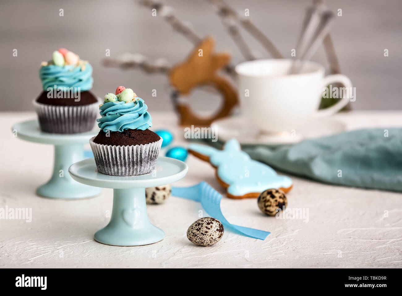 Tasty Easter cupcakes on table Stock Photo