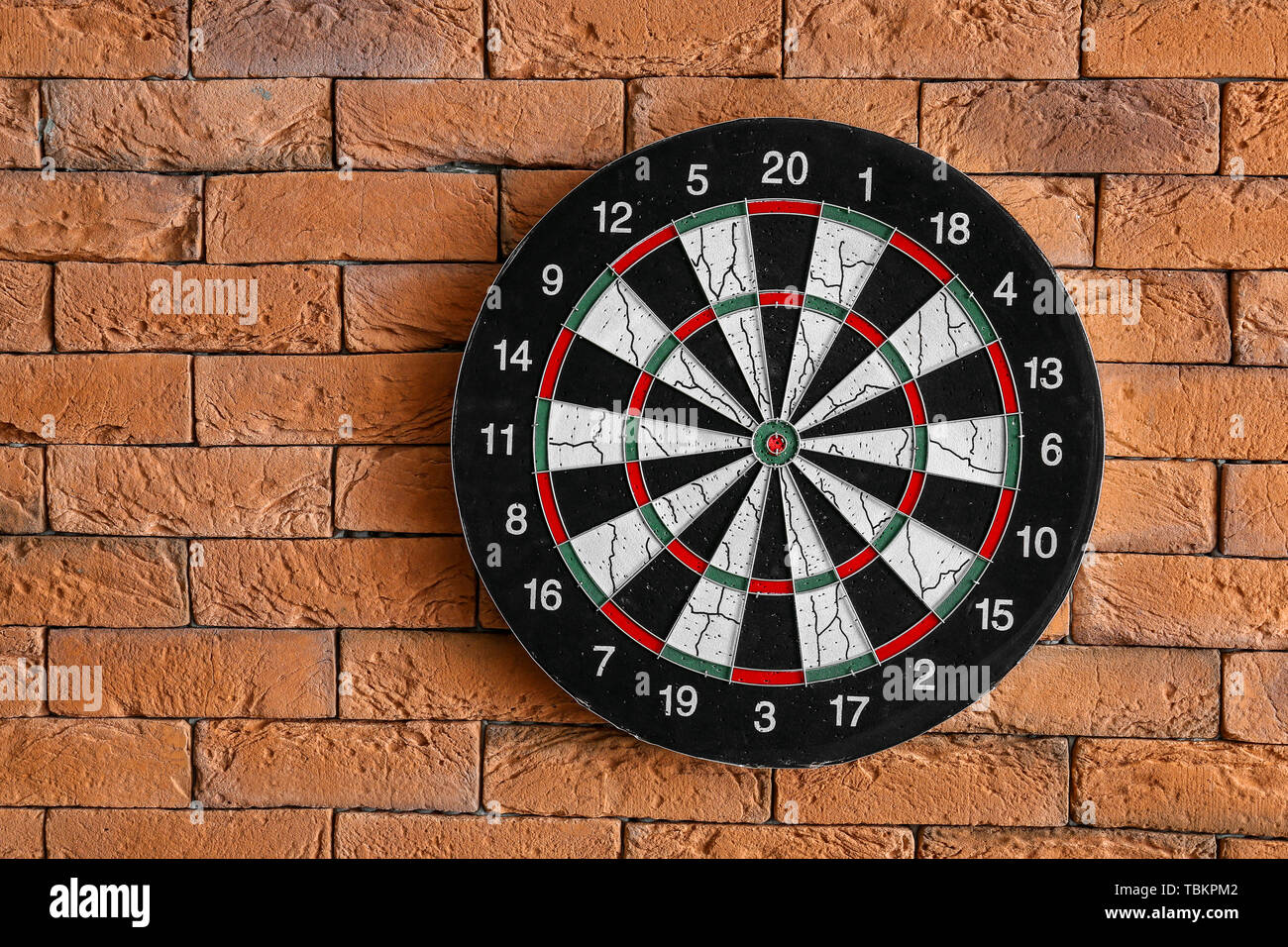 Dartboard on brick wall Stock Photo Alamy