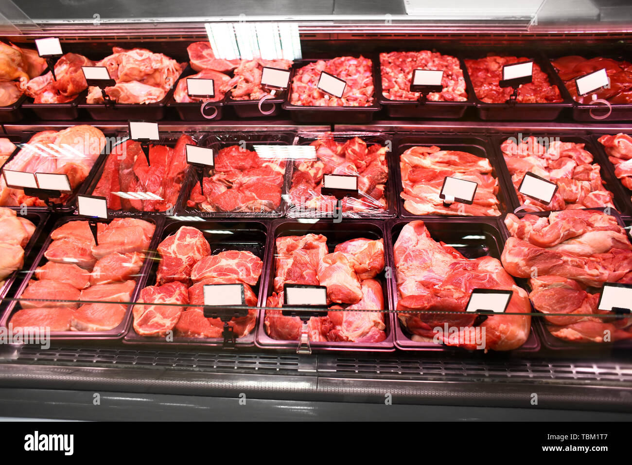Refrigerated display case with fresh meat in supermarket Stock Photo - Alamy