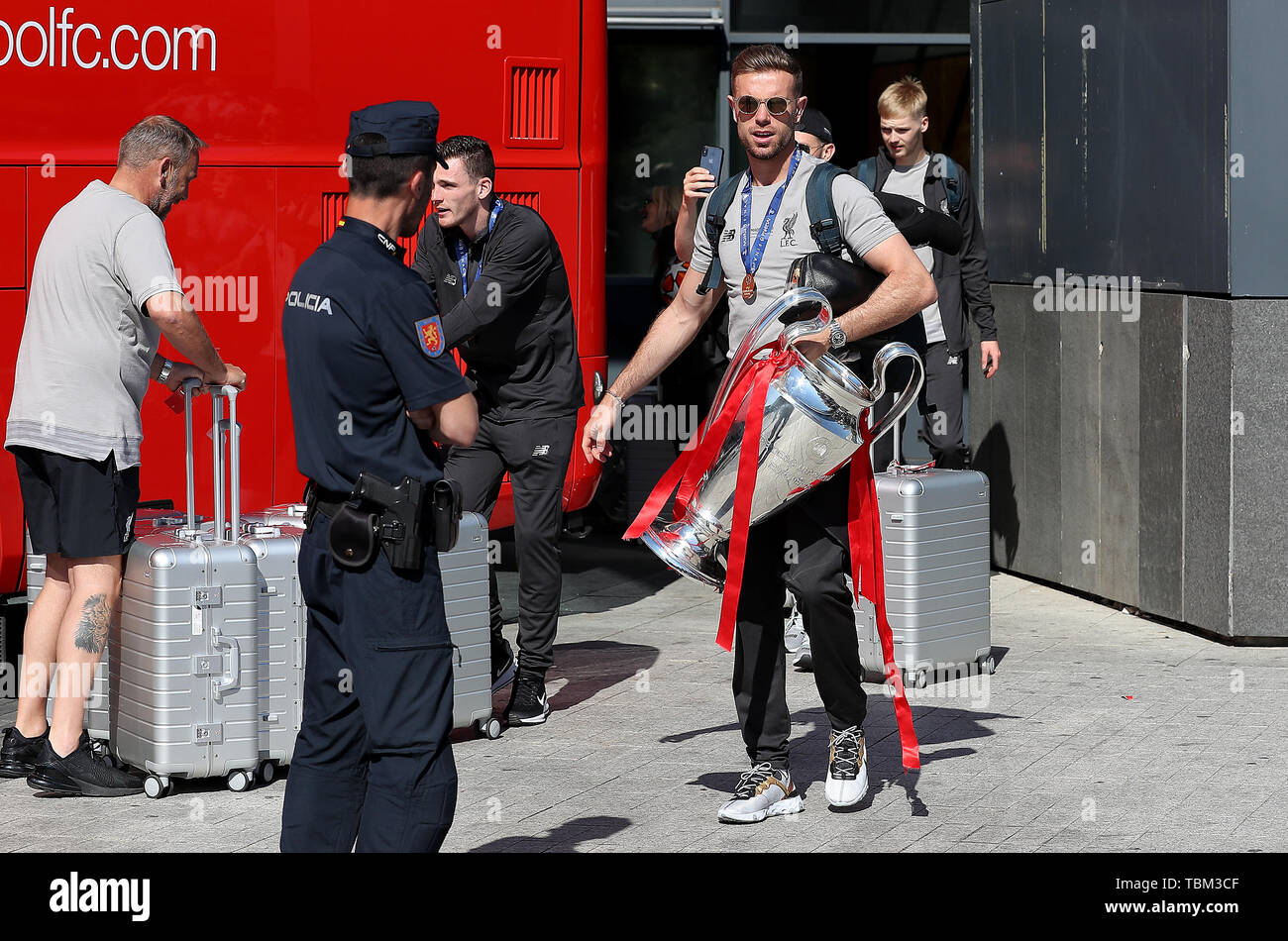 Liverpool captain Jordan Henderson leaves the Eurostars Madrid Tower Hotel holding the Champions League trophy, as the team travel home for a homecoming parade. Stock Photo