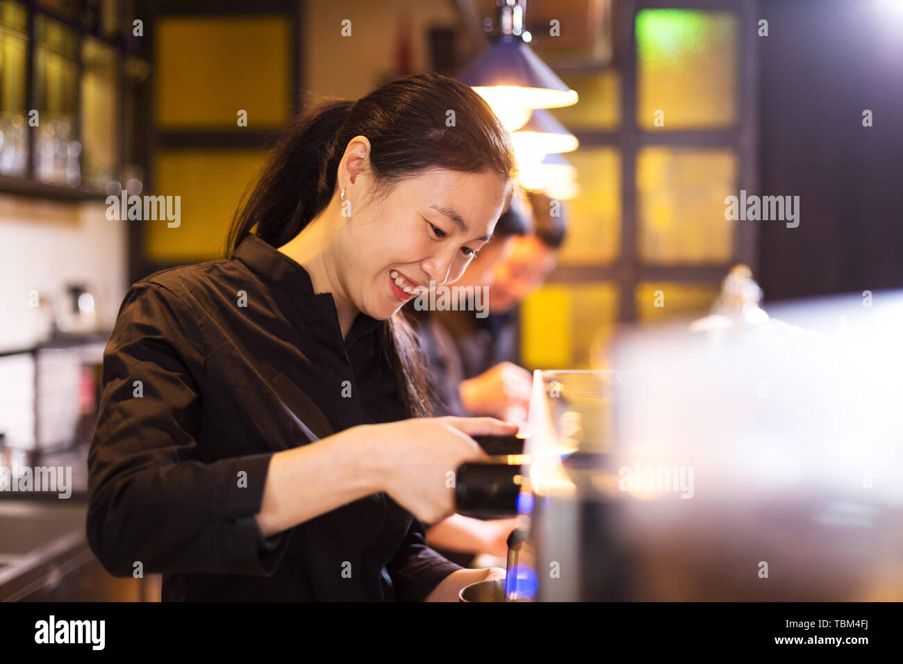 waitress serving in modern cafe Stock Photo