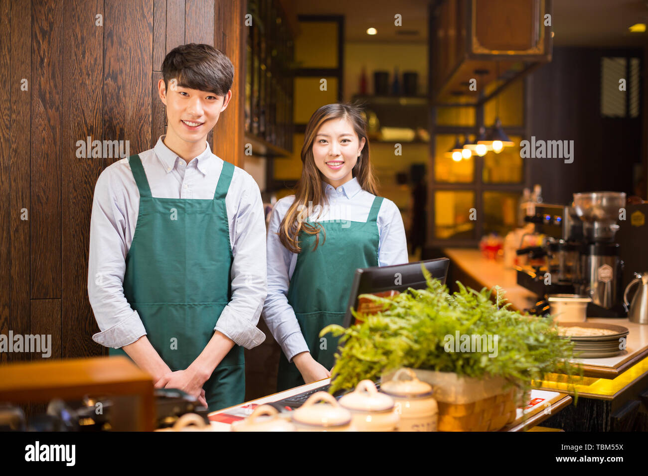 Make Waiters Make it waitress and waiter in cafe Stock Photo - Alamy