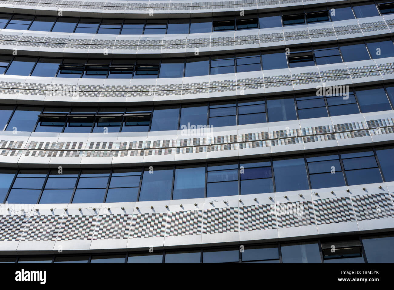 Modern office building with glass wall Stock Photo - Alamy