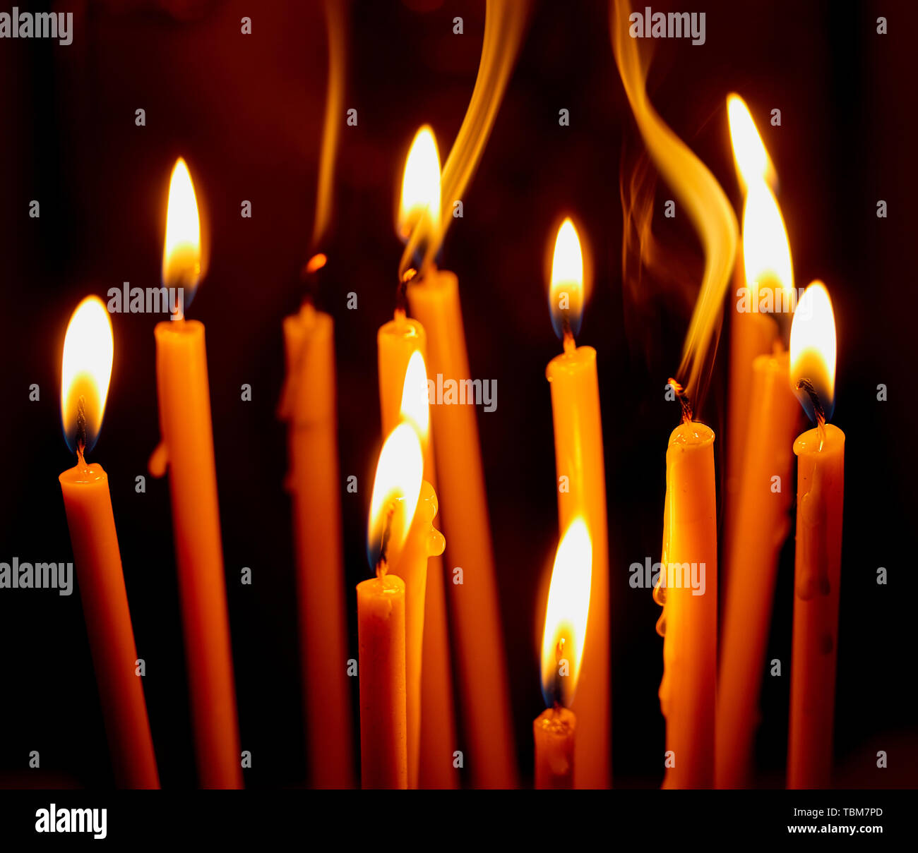 Church candles burning in the dark create a spiritual atmosphere. Hope