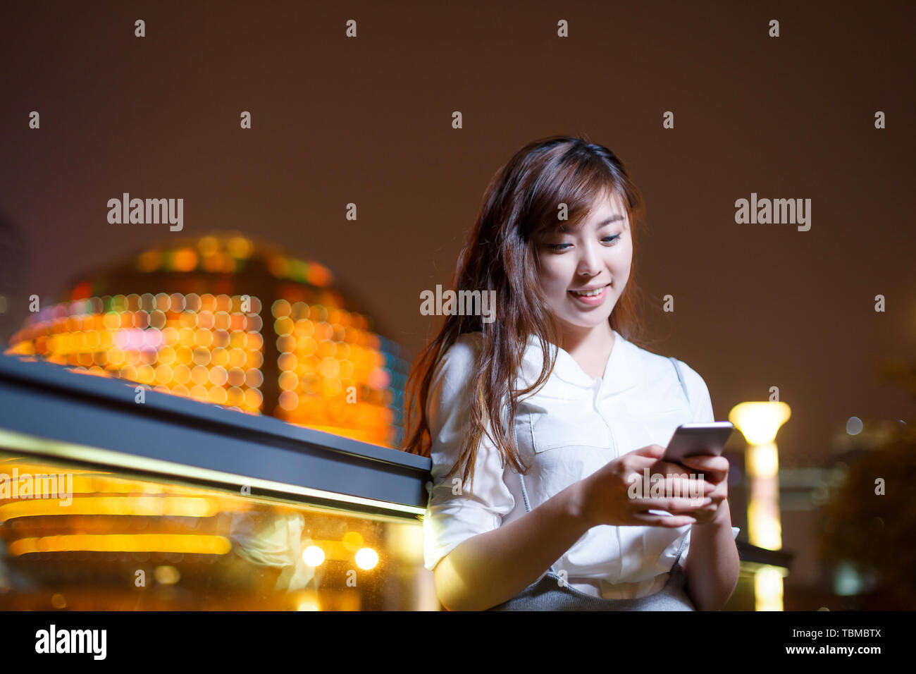 beautiful asian girl using mobile phone at night Stock Photo - Alamy