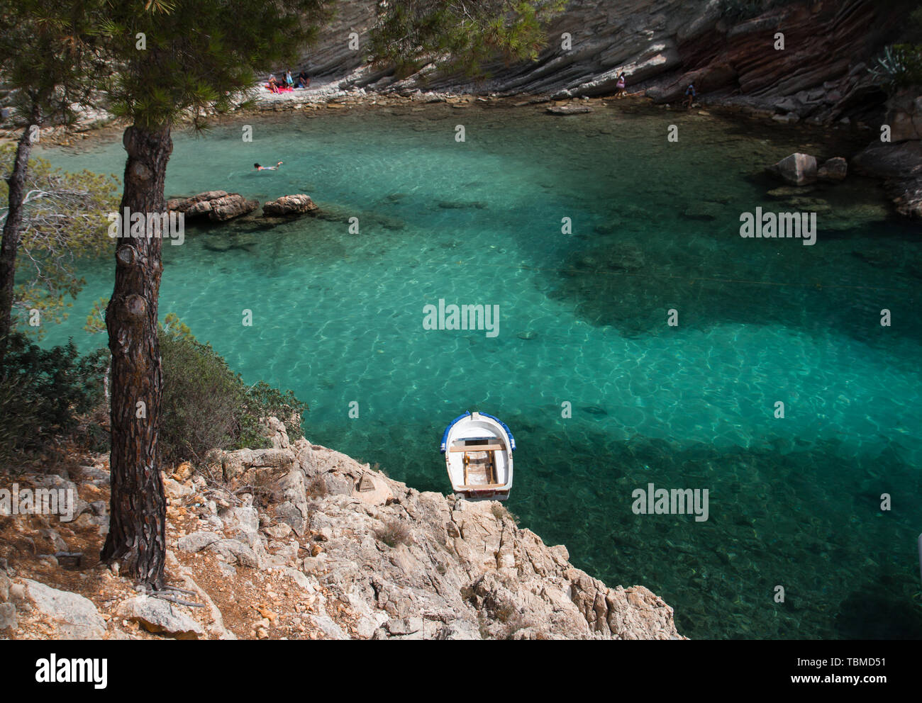 small boat anchor in turquoise water sea bay Stock Photo