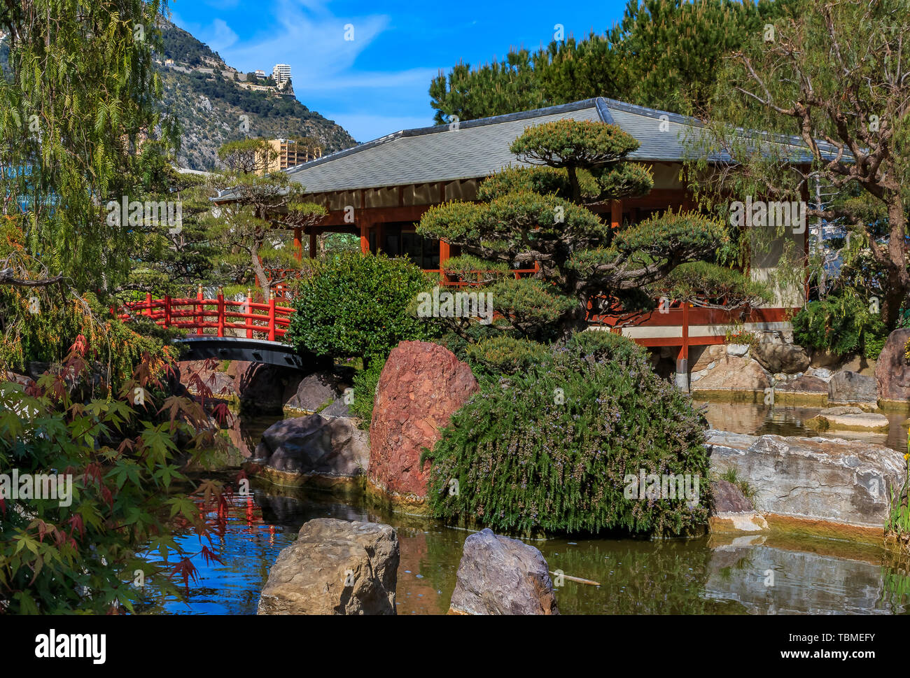 Red pagoda and a koi pond in the tranquil Japanese Garden or Jardin Japonais in Monaco, Monte Carlo Stock Photo